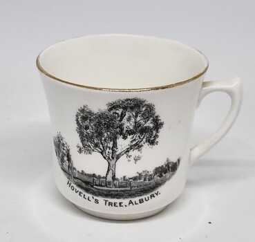 White china cup bearing a black image of the Hovell Tree in Albury.