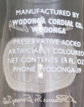 Manufacturer and contents information in white on back of bottle