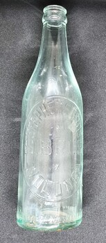 Small clear glass drink bottle embossed with Stephen Bros Wodonga