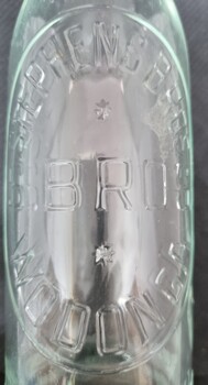 "Stephen Bros Wodonga" embossed on clear glass bottle