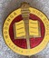 A circular badge representing Wodonga High School. The centre includes a torch and an open book.