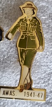 Badge recognising AWAS 1941-47 in the shape of a woman in military uniform. Brown and white enamel.