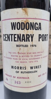 Label on the one of the bottles showing details of the centenary date. Bottles have been signed by the Council members in 1975