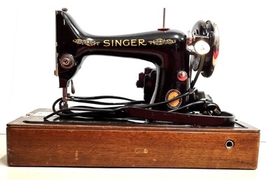 Singer electric sewing machine - front view with electric cord.