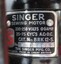 Sewing machine specifications attached to machine on metal plate.