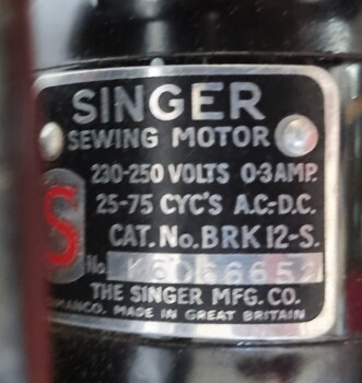 Sewing machine specifications attached to machine on metal plate.