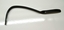 Metal knee bar inserted in hole at front of machine and pressed to adjust speed.