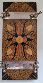 Flower Press front view showing metal closures and parquetry design.