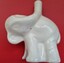 A white ceramic pie funnel in the shape of an elephant.