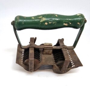 Metal and wood rollet used to cut herbs before cooking.