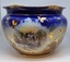 Large decorative ceramic bowl with rural scenes and gilt decoration