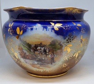 Large decorative ceramic bowl with rural scenes and gilt decoration