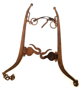 Metal hames which form part of a horse harness including leather strap.
