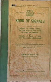 Beige coloured book with green print and binding outlining railway signal system in Victoria
