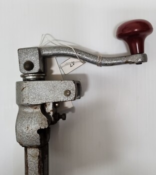 Top of can opened showing red rotating handle and blade attachment