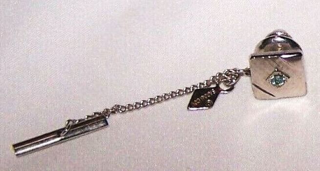 Small tie pin with blue stone showing chain and clip