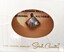 Tin pin in  packet with clear central window and Sarah Coventry logo