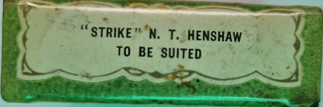 Logo on side of matchbox holder featuring business name