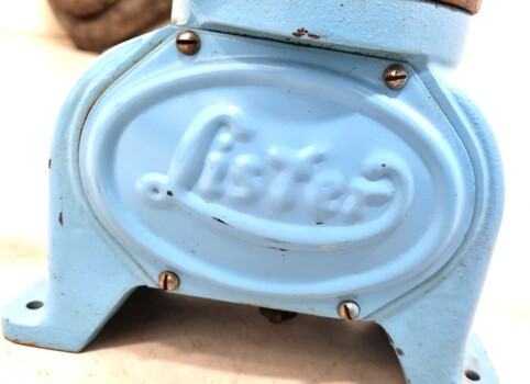 Blue base of separator showing Lister brand name  imprinted on the side. The side panel is attached by screws