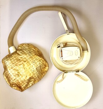 Hair dryer showing case including 4 speed motor,  hood with attached hose and electrical cord