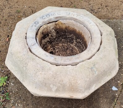 HEwn stone font with inscription