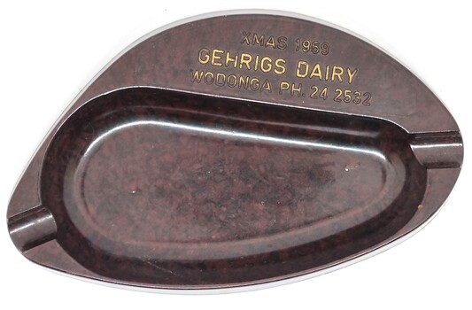 Brown oval-shaped ashtray with name inscribed