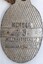 Rear of badge showing member number and maker's mark.