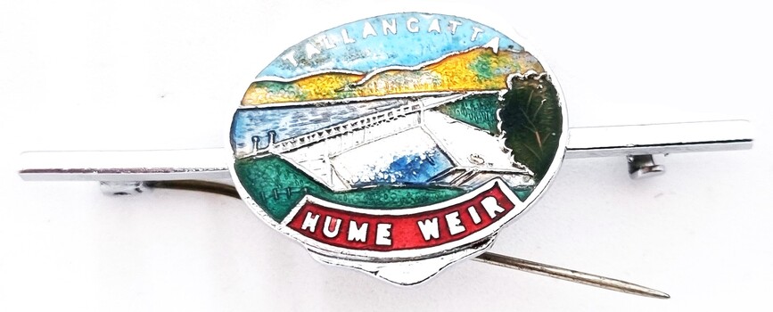Small enamelled tie pin bearing image of the Hume Weir