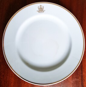 Full view of plate showing red logo at top