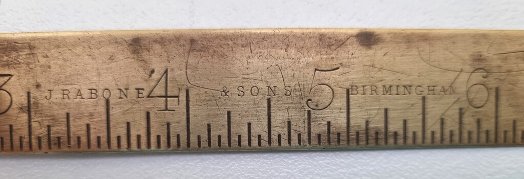 Ruler showing name of manufacturer and inche markings