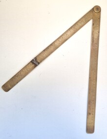 A brass folding ruler with 2 sections of 12 inches
