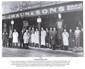 Photo of staff of J. Mann & Sons lined up outside the business.