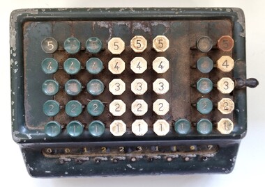 Adding machine top view showing 6 rows of keys and handle on the side.