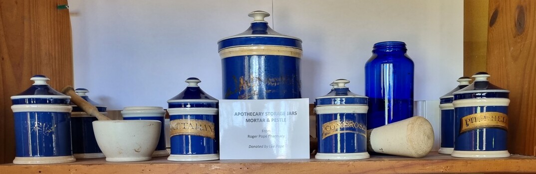 Set of blue and white apothecary jars and 2 mortar and pestles.