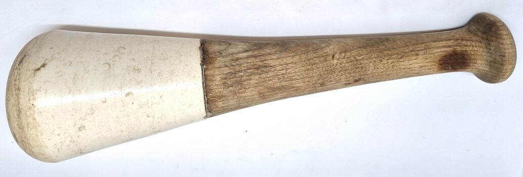 Large mortar with wooden handle and ceramic top.