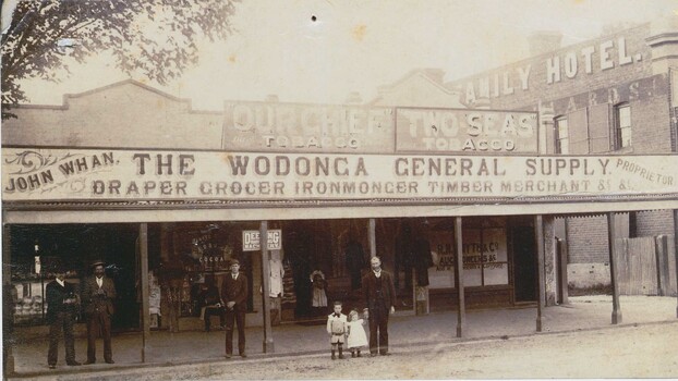 Image showing people outside the store including John Whan and 2 grandchildren.
