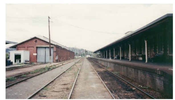 A view of old Wodonga Stations including goods sheds on the left of the tracks and booking office on the right.