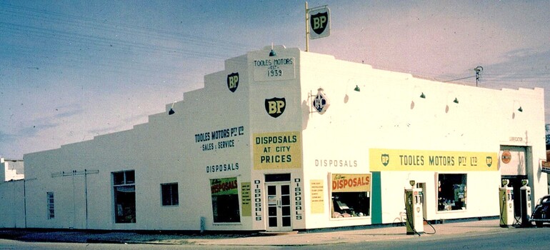 Toole's building c1965 advertising Toole's Motor and also disposals.