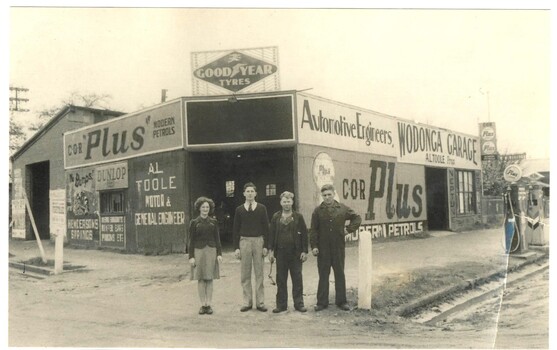4 staff members standing outside the premises of A. L. TOOLE.