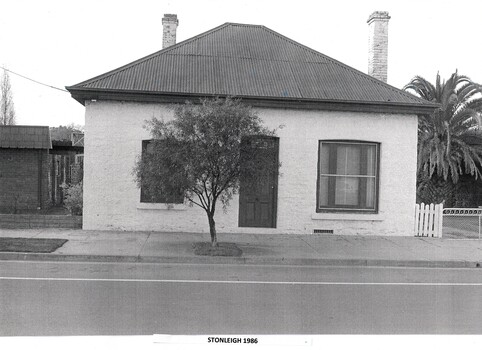 Stone building with central door, 2 sash windows and 2 chimneys