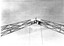 Connecting the 2 boomerangs to form an arch. Worker on top setting them in place.