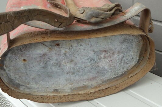 Bottom view including metal brace contoured to fit into user's back.