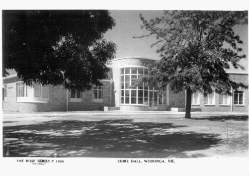 A Rose Series postcard of the Wodonga Shire Hall. The building is made of brick with large windows.