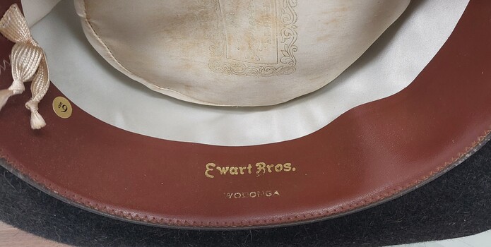 Name of Ewart Bros. Embossed inside hat brim.