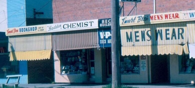 Ewart Bros. Bookshop on left and Ewart Bros. Menswear on right.