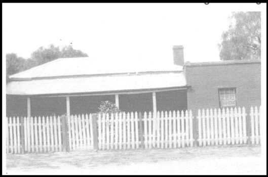An old homestead with a picket fence.