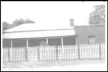An old homestead with a picket fence.