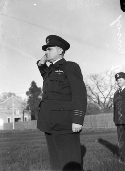 WIng Commander James S.N. Harris salutes after receiving the RAAF Long Service Commendation