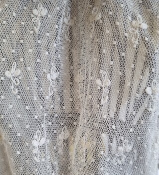 Embroidered lace underlay on camisole.