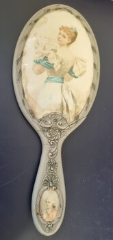 Hand painted mirror with image of a woman looking over her shoulder towards artist.